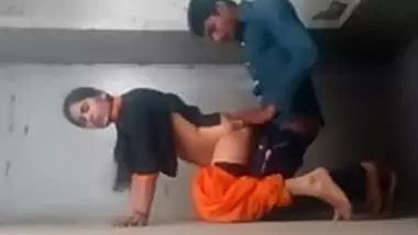 It looks like an amateur Indian couple is having sex on the wall