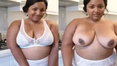 Enchanting Indian woman with nose piercing takes off white bra