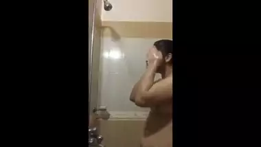 a cute bubbly beauty bathing in shower