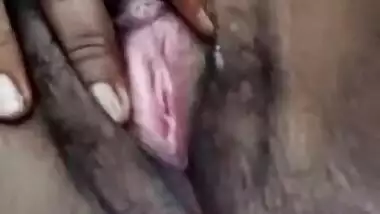 Young village girl spreads legs to rub virgin Desi bush in XXX video