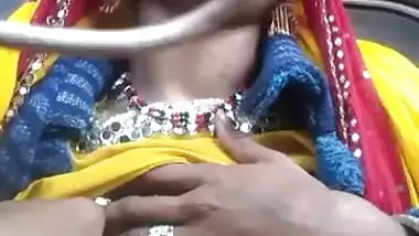 Desi chick pulls her bright dress up to demonstrate big XXX boobs