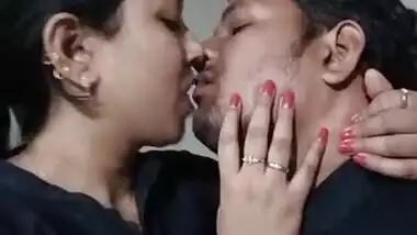 Sexy couple smooching in office